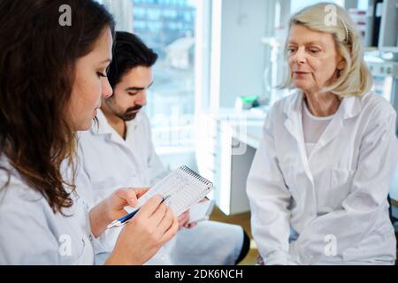 Scientists talking in laboratory Stock Photo