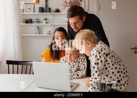 Family at home using laptop Stock Photo