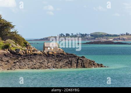 The stone house is on the tidal island of les Ebihens near the corsair town of Saint Malo. It can be reached from the mainland at low tide. Brittany, France Stock Photo