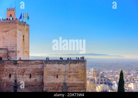 Granada, Spain - January 7, 2020: Torre de la Vela – The Watch Tower at Alhambra complex. Visitors enjoy the marvelous view of the city from the top o