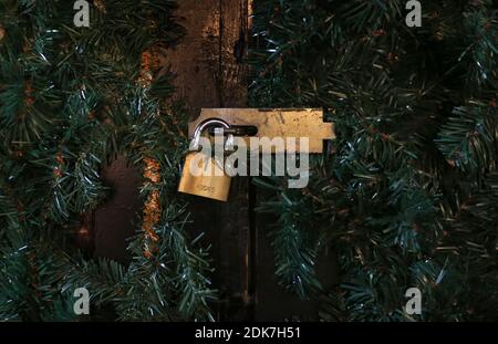 14 December 2020, Bavaria, Würzburg: The Christmas decorated door of a stall at the Christmas market is closed with a padlock. Photo: Karl-Josef Hildenbrand/dpa Stock Photo