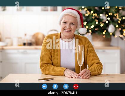 Mature woman having online party on New Year, copy space Stock Photo