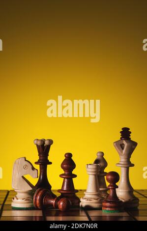 Creative background with wooden board and chess figures. Stock Photo