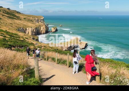 Tourists on the way to Tunnel Beach, Dudedin, Otago, South Island, New Zealand, Oceania Stock Photo