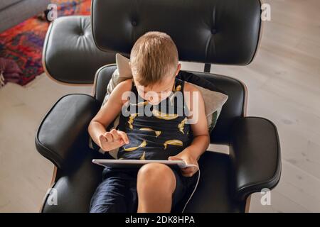Boy using digital tablet Stock Photo