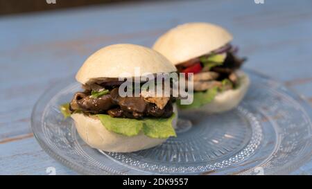 An Asian-style vegetarian steamed bun dish with seitan and Portobello mushrooms Stock Photo