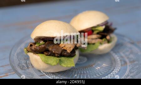 An Asian-style vegetarian steamed bun dish with seitan and Portobello mushrooms Stock Photo