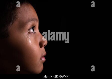 Close-up Of Sad Boy Over Black Background Stock Photo - Alamy