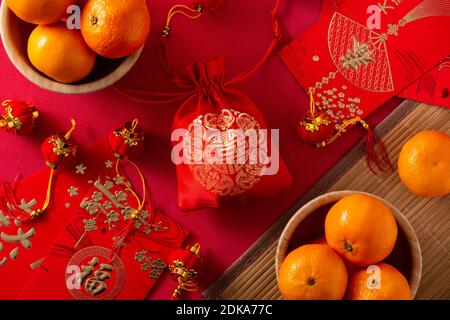 Chinese new year festival decorations and oranges on red background Stock Photo