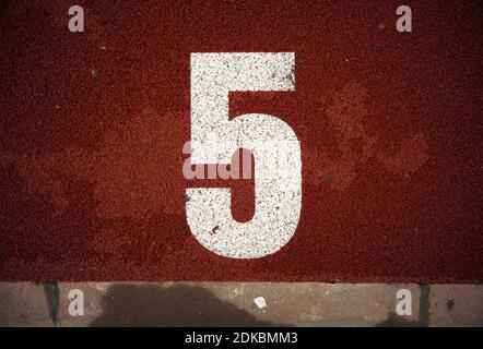 Closeup view of number on athlete path. Stock Photo