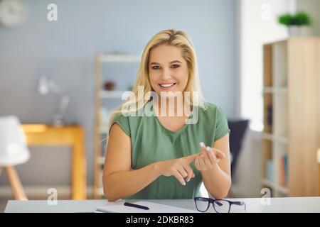 Happy smiling online tutor or coach talking to students or clients during online video call Stock Photo