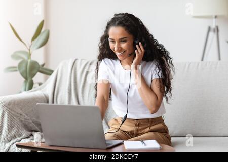 Beautiful young woman having video call, using laptop Stock Photo