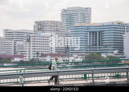 An elderly man seen wearing a face mask while walking on the bridge in Bangkok.People wear protective masks as air pollutant PM2.5 rises to unhealthy levels in Bangkok. Stock Photo