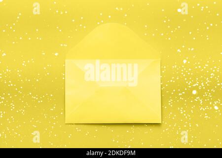 Color trend 2021 - Yellow envelope on a yellow background. Flat lay concept for valentines day, womans day, wedding or birthday Stock Photo