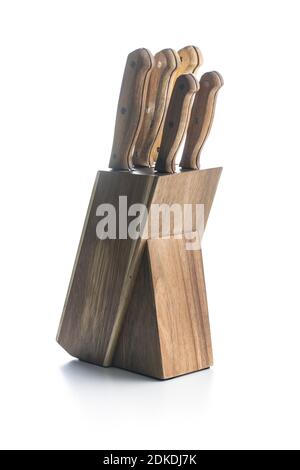 Knives in stand. Set of kitchen knives in wooden block isolated on white background. Stock Photo