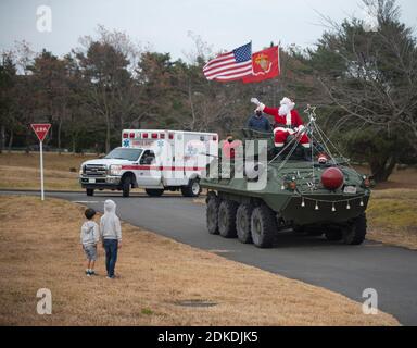 Santa Claus waves from on top an amphibious combat vehicle during the Christmas tree lighting ceremony at the Combined Arms Training Center Camp Fuji December 13, 2020 in Shizuoka, Japan. Stock Photo