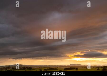 The Peißenberg near Weilheim in the Bavarian Prealps seen from a small hilltop during sunset. Stock Photo