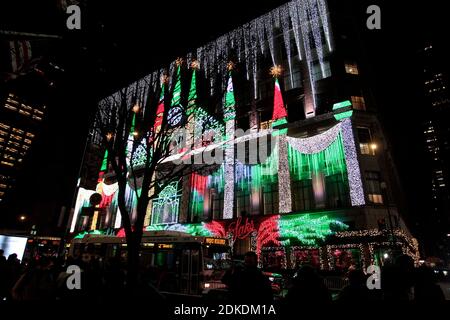 New York City, New York, United States. 15th Dec, 2020. Christmas light show at New York's Saks Fifth Avenues store, famed for its Christmas displays and windows. Normally packed this time of year, the street was largely absent of pedestrians, with only a handful of people taking in the spectacle due to the coronavirus pandemic. Credit: Adam Stoltman/Alamy Live News Stock Photo