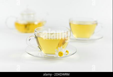 glass cups and teapot with chamomile tea on a white background. a bouquet of daisies Stock Photo ...