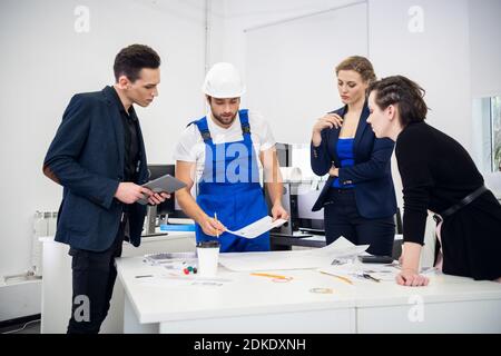 A group of professional engineers giving a careful consideration to a project. Stock Photo