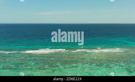Blue background with transparent sea water copy space for text. Sea water surface in lagoon and coral reef. Top view transparent turquoise ocean water surface. background texture Stock Photo