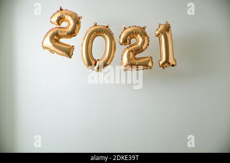 2021 inflated balloon numbers on white indoor background. Stock Photo