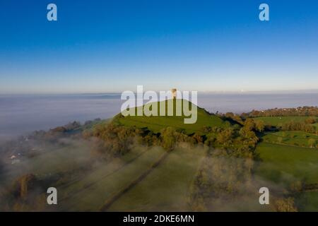 Mist surrounds Glastonbury Tor in Somerset. Stock Photo