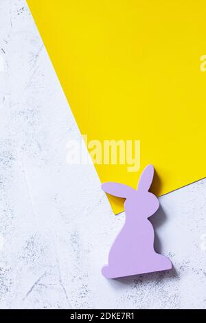 Easter bunny on slate background. Happy Easter mockup. Illuminating Yellow and Ultimate Gray Color of the year 2021. Top view flat lay background. Stock Photo