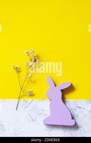 Happy Easter mockup. Easter bunny on slate background. Illuminating Yellow and Ultimate Gray Color of the year 2021. Top view flat lay background. Stock Photo