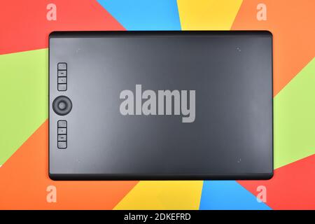 Top view professional graphics tablet. Isolated on multicolored background. High resolution photo. Full depth of field. Stock Photo
