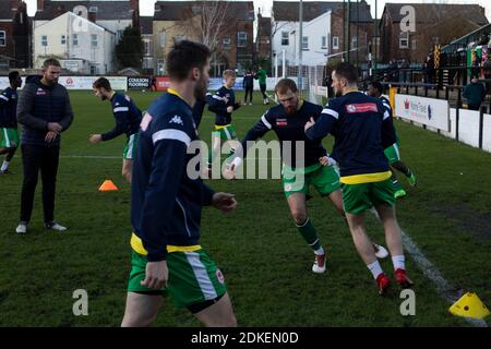 The visiting players warming up before Marine play Hyde United in an FA Trophy first round tie at the Marine Travel Arena, formerly known as Rossett Park, in Crosby. Due to coronavirus regulations which had suspended league games, the Merseysiders’ only fixtures were in cup competitions, including their forthcoming tie against Tottenham Hotspur in the FA Cup third round. Marine won the game by 1-0, watched by a permitted capacity of 400, with the visitors having two men sent off in the second half. Stock Photo