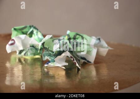 crumpled hundred USA dollars banknoted on shiny background. Wasted money failed business plan concept. Stock Photo
