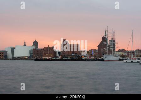 Germany, Mecklenburg-Western Pomerania, Stralsund, sunset, skyline of the Hanseatic city of Stralsund with the Ozeaneum and the sailing ship Gorch Fock I Stock Photo
