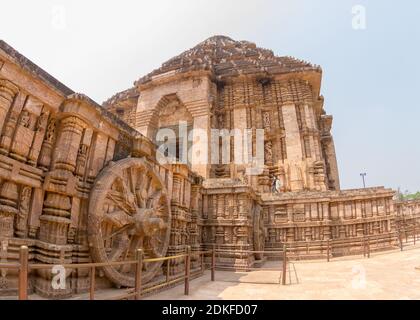 Ancient Hindu Sun Temple and chariot wheel intricate carvings on the walls in Konark, Orissa, India. 13th-century CE. The temple is attributed to king Stock Photo