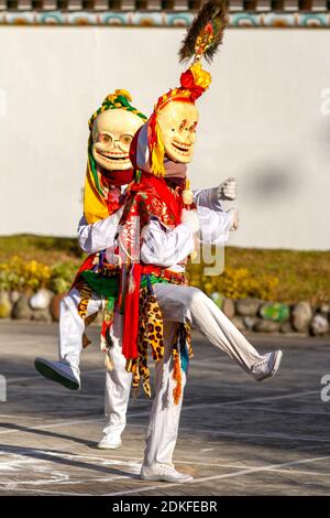 Unidentified monks in Citipati protector deity masks perform religious masked and costumed mystery dance of Tantric Tibetan Buddhism on Cham Dance Fes Stock Photo