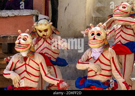 Unidentified monks in Citipati (protector deity) masks perform a religious masked and costumed mystery dance of Tantric Tibetan Buddhism on Cham Dance Stock Photo