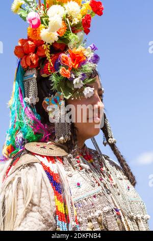 Leh, Jammu and Kashmir, India - Sep 01, 2012: The woman of Dard ethnic group in traditional clothing with the familiar ornate headgear in the processi Stock Photo