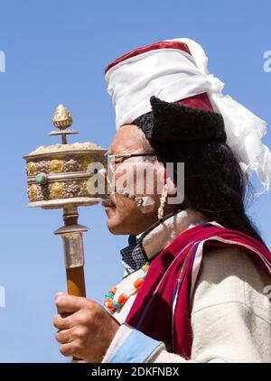 Leh, Jammu and Kashmir, India - Sep 01, 2012: the Ladakhi man with hand prayer wheel in traditional clothing with the familiar hat  on the traditional Stock Photo