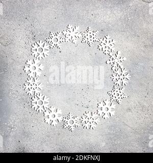 Christmas composition. Christmas frame made of snowflakes on gray stone background. Winter concept. Flat lay, top view, copy space. Stock Photo