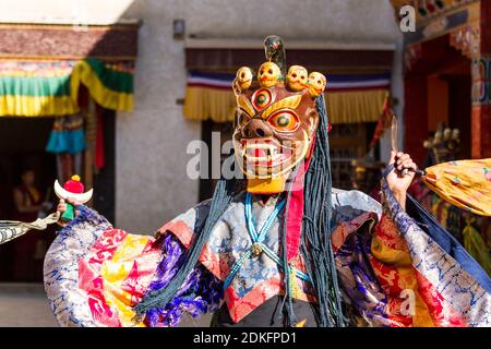 Unidentified monk in mask performs a religious masked and costumed mystery dance of Tibetan Buddhism during the Cham Dance Festival in Lamayuru monast Stock Photo