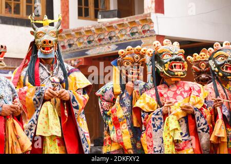 Unidentified monks in masks perform a religious masked and costumed mystery dance of Tibetan Buddhism during the Cham Dance Festival in Lamayuru monas Stock Photo