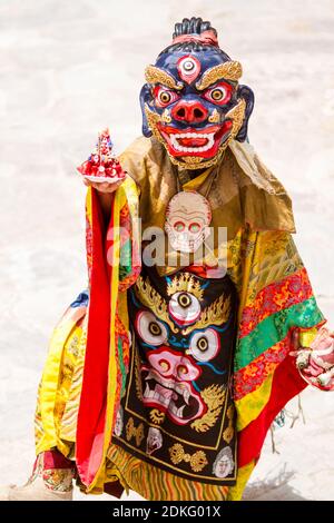 Unidentified monk performs a religious masked and costumed mystery dance of Tibetan Buddhism during the Cham Dance Festival in Hemis monastery, India. Stock Photo