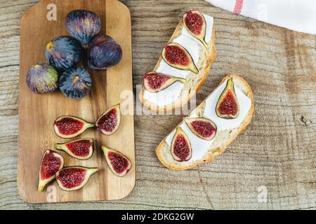 Figs with fresh cheese on toast Copy space. Stock Photo