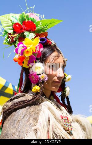 Leh, Jammu and Kashmir, India - Sep 01, 2012: The woman of Dard ethnic group in traditional clothing with the familiar headgear in the processing on t Stock Photo