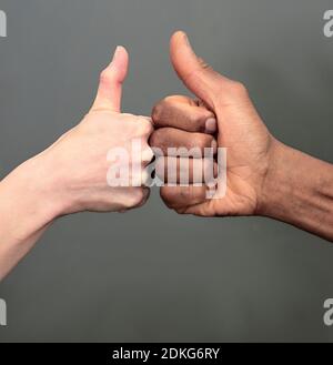 hand gesture showing no discrimination between black and white on dark background stock photo Stock Photo