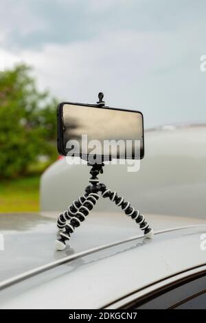 Articulating mini tripod for photography holding a smartphone Stock Photo
