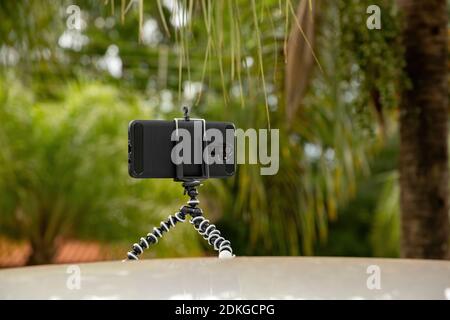 Articulating mini tripod for photography holding a smartphone Stock Photo