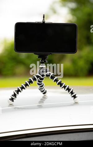 Articulating mini tripod for photography holding a smartphone Stock Photo