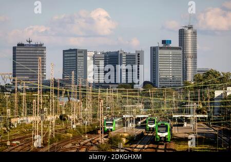 Essen, Ruhr area, North Rhine-Westphalia, Germany - city panorama with Postbank Tower, Evonik headquarters and RWE tower, in front S-Bahn at Essen West station. Stock Photo