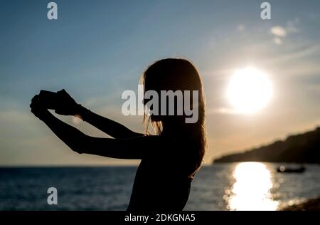teenager mit smartphone am Strand
